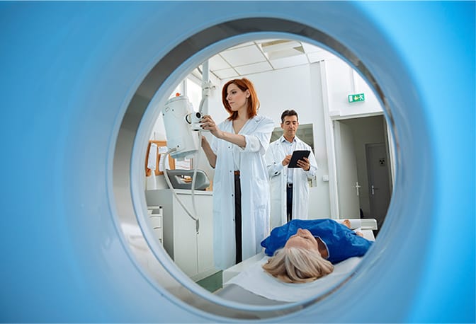 radiology techs prepare female patient for mri exam